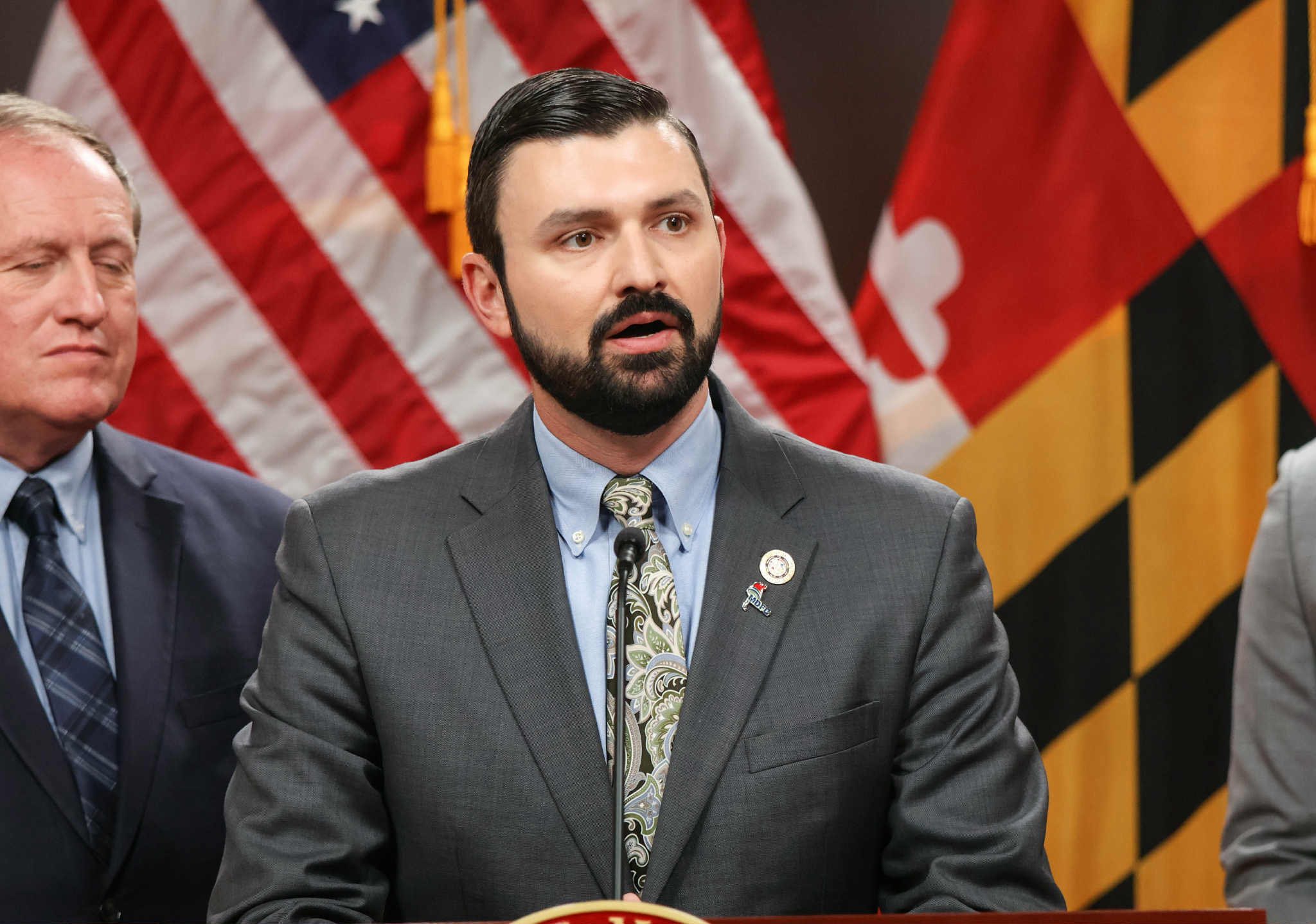 Ryan at a press conference with the Maryland flag