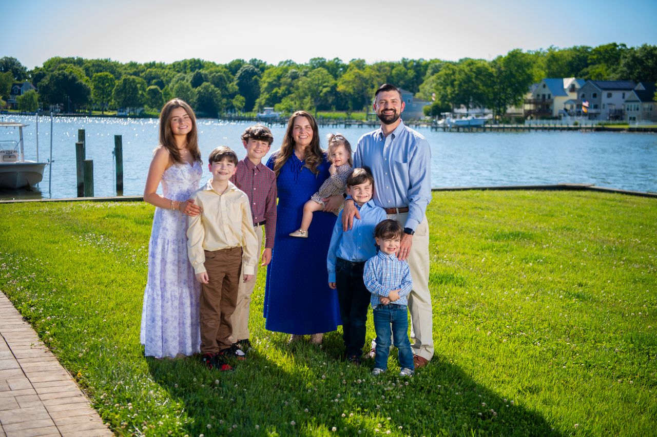 Ryan and Dr. Lauren Nawrocki with their six children by the water